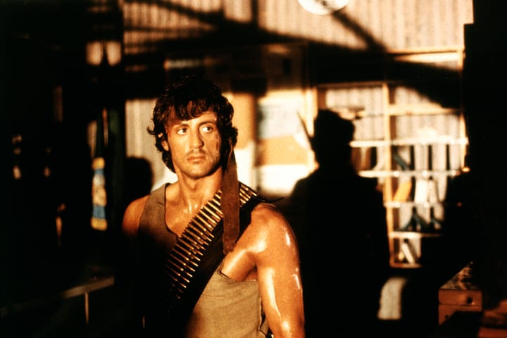 Who was considered for the role of John Rambo in First Blood before Sylvester Stallone?